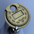 Coin Type Spark Plug Gauge Used As A Tool For Adjusting The Gap Between Automotive Spark Plugs
